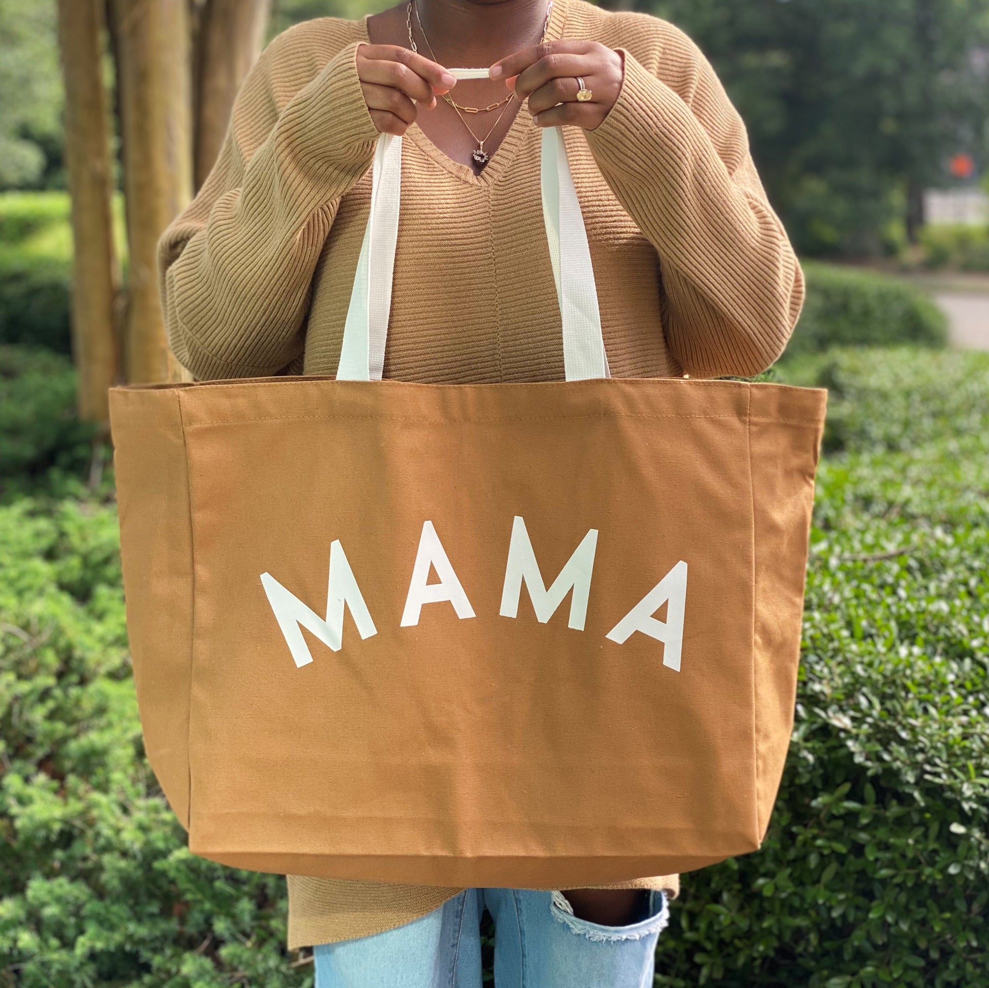  Canvas fabric tote features MAMA design printed on front.